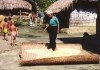 Bangladesh - Marma village: working the grain to dry (photo by Galen Frysinger)