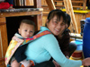 China - Hainan Island: mother and baby preparing chicken (photo by G.Friedman)