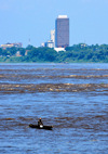 Kinshasa, Democratic Republic of the Congo:  Livingstone Falls / Chutes du Djou -  rapids on the lower course of the Congo River, border between the Congos - man steering a pirogue - CCIC building (Chambre de Commerce et d'Industrie Inde Congo) / Fleuve Congo Hotel, Boulevard Tshatshi, Gombe - photo by M.Torres