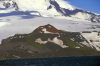 Heard Island: hidden colors - a red cinder cone flanked by green patches amid the snow - photo by F.Lynch