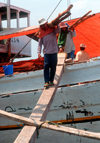 Sunda Kelapa, South Jakarta, Indonesia - unloading a phinisi boat  - old port of Sunda Kelapa - estivadores - photo by B.Henry