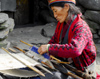 Nepal - Langtang region - old woman weaving a carpet - photo by E.Petitalot