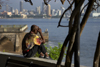 Panama City / Ciudad de Panam: man looking at the city from Las Bovedas in the Casco Viejo - photo by H.Olarte