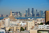 Doha, Qatar: old and new Doha - old town skyline with the FANAR minaret and the towers on West Bay skyline accross Doha bay - photo by M.Torres