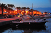 S. Antoco, S. Antoco island, Sardinia / Sardegna / Sardigna: palm trees and boats along the waterfront avenue - Lungomare C. Colombo - nocturnal - Sulcis-Iglesiente region - photo by M.Torres