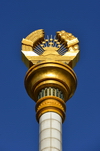 Dushanbe, Tajikistan: Parchan column bearing the Tajikistani national emblem / coat of arms - Soviet style frame with crown, sun and the Pamir mountains - photo by M.Torres