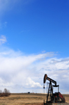 Thunder Basin National Grassland, Wyoming, USA: pumpjack and sky - nodding donkey - Lufkin oilfield pumping unit - reciprocating piston pump over an oil well near WY-59 - photo by M.Torres