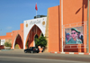 Layoune / El Aaiun, Saguia el-Hamra Western Sahara: Palais des Congrs and a portrait of King Mohammed VI in battledress, just in case the locals have any doubts about who calls the shots - Place du Mechouar - photo by M.Torres