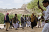 Wadi Dhahr, Al-Mahwit Governorate, Yemen: men with Jambiya daggers performing wedding dance outside Dar al-Hajar palace - photo by J.Pemberton