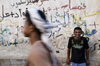 Al Hudaydah / Hodeida, Yemen: local man in front of graffitied wall - photo by J.Pemberton