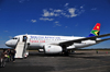 Victoria Falls, Matabeleland North, Zimbabwe: Victoria Falls Airport - VFA - passengers from Johannesburg disembark from an airliner onto the tarmac - South African Airways Airbus A319, cn 2418, ZS-SFK (ex D-AVYI) - SAA - Suid-Afrikaanse Lugdiens - photo by M.Torres