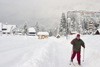 Slovenia - Man cross country skiing in the village Ribcev Laz near Bohinj Lake - photo by I.Middleton