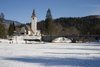 Slovenia - Ribcev Laz - People walking and ice skating on Bohinj Lake when frozen over - Church of St John the Baptist and stone bridge - photo by I.Middleton